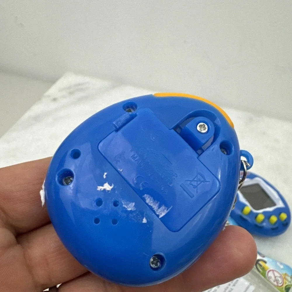 2 Collectors Tamagotchi With Crack On Plastic On Right Side Still Works